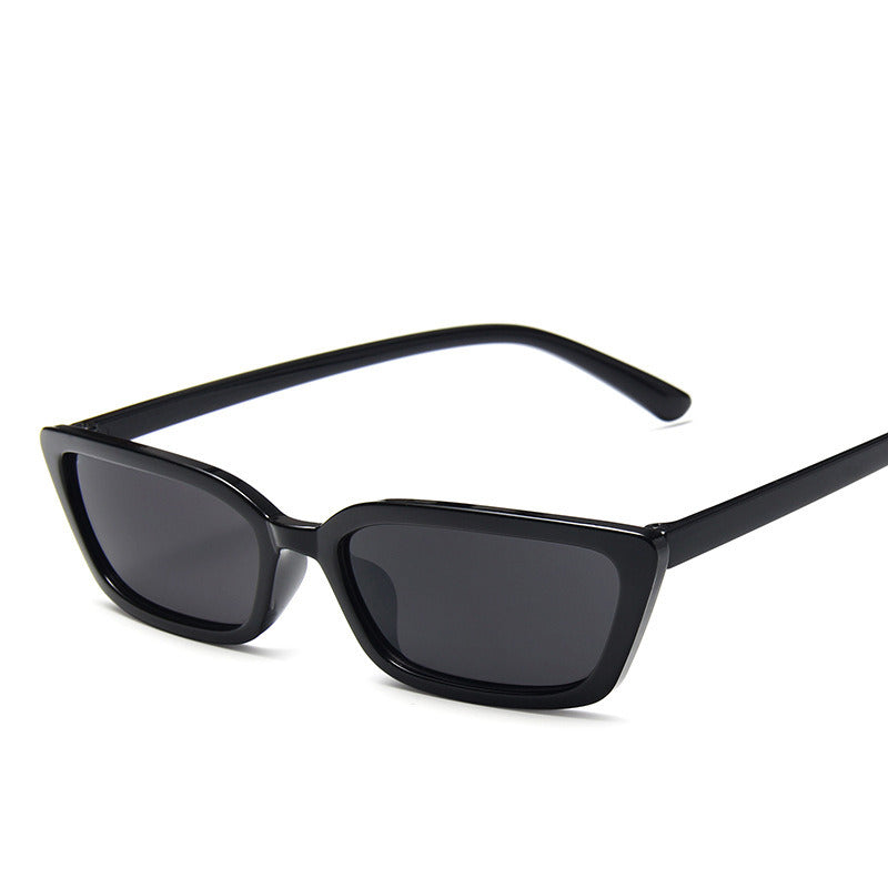 Black sunglasses with dark lenses on a white background