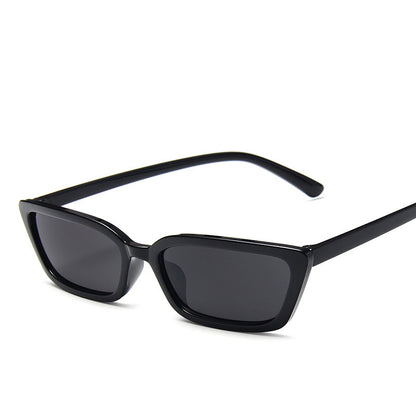 Black sunglasses with dark lenses on a white background