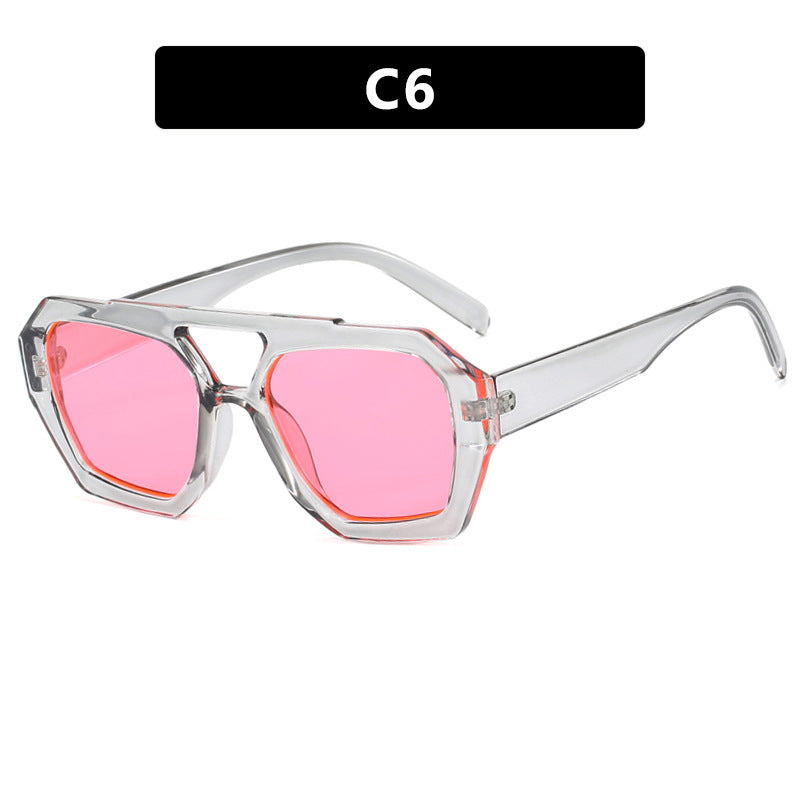 Sunglasses with pink lenses and clear frame on a white background
