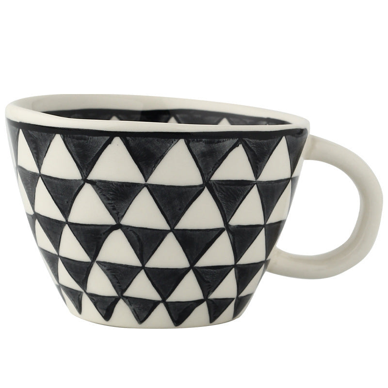 Ceramic mug with black and white triangle pattern on a white background