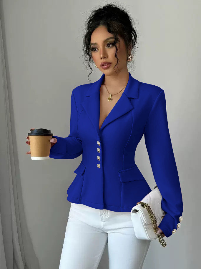 Woman wearing a blue blazer holding a coffee cup against a plain background
