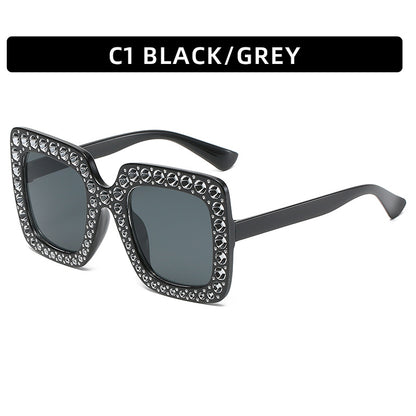 Black and gray sunglasses with decorative elements on a white background