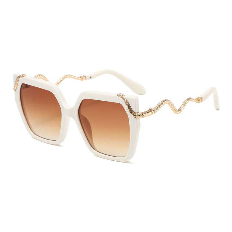 White sunglasses with gold accents on a white background