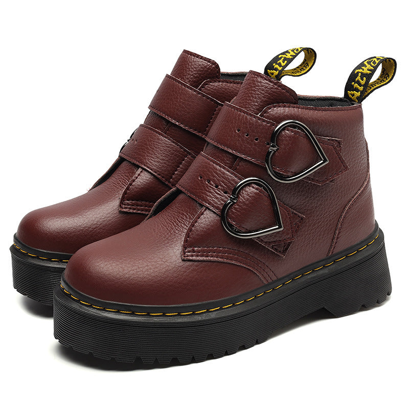 Brown leather boots with heart-shaped buckles on a white background