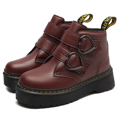 Brown leather boots with heart-shaped buckles on a white background