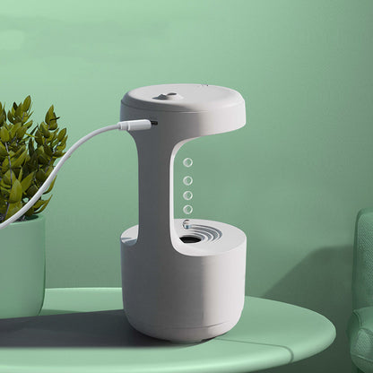 White lamp with USB cable on a green surface against a green wall