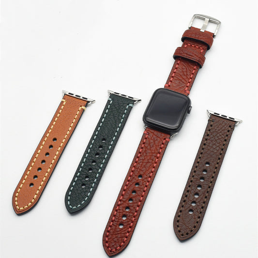 Four leather watch straps in different colors on a white background