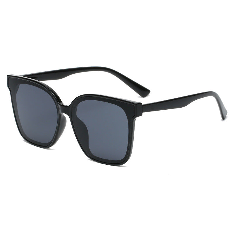 Black sunglasses with dark lenses on a white background
