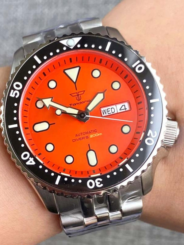 Orange dial diving mechanical watch with black bezel and steel link bracelet
