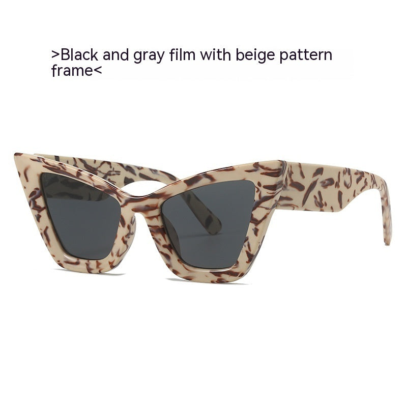 Sunglasses with beige pattern frame and black lenses on a white background