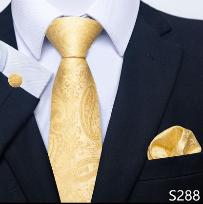 Gold paisley tie and pocket square set with navy suit and white shirt