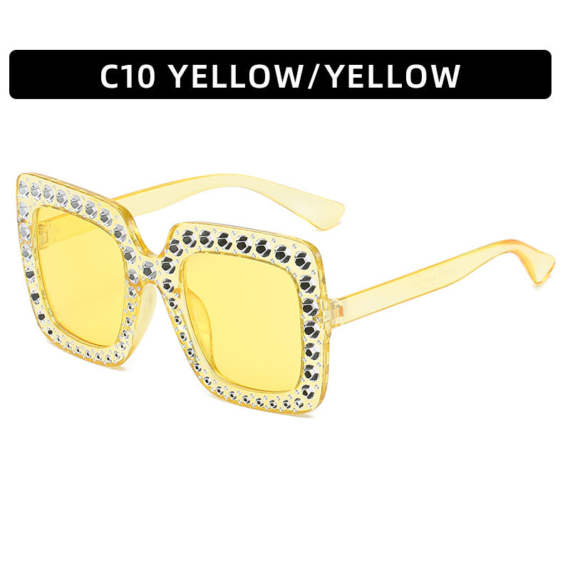 Yellow sunglasses with decorative elements on a white background