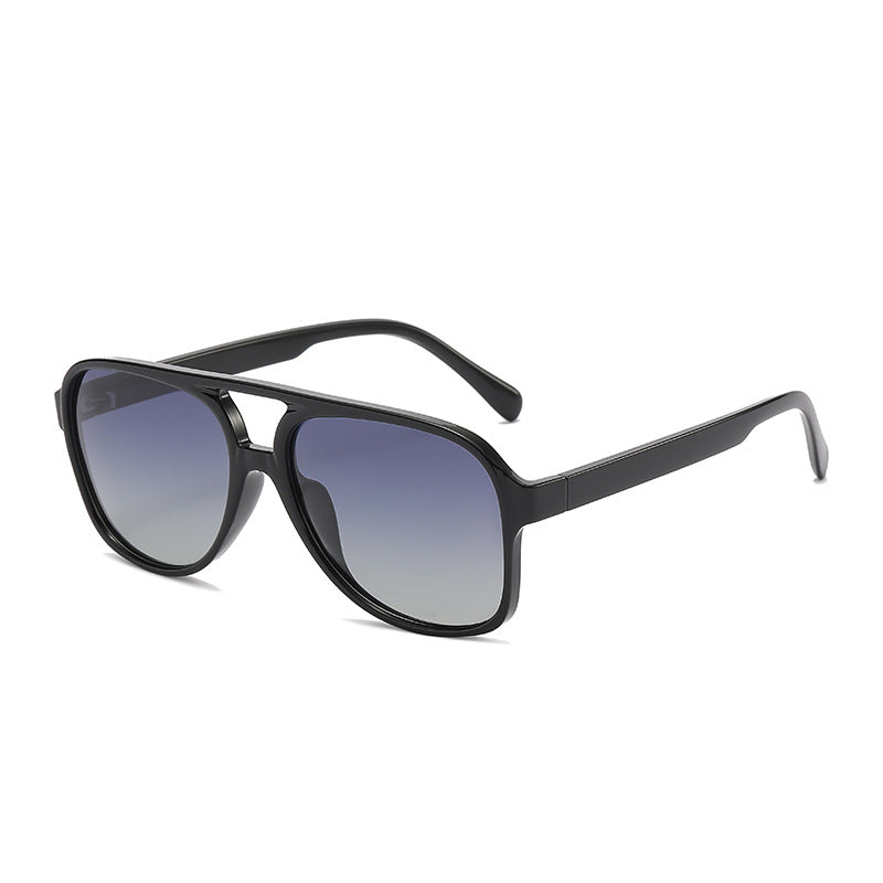 Black sunglasses with gradient lenses on a white background