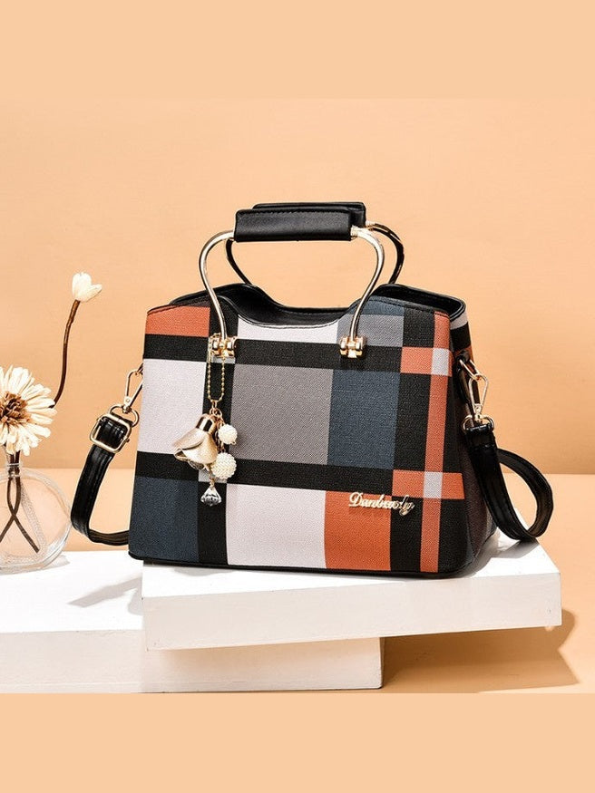 Plaid patterned handbag with decorative elements on a beige background