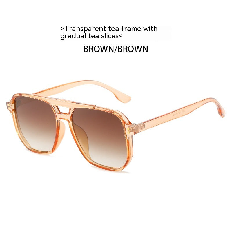 Sunglasses with transparent tea frame and brown gradient lenses on a white background