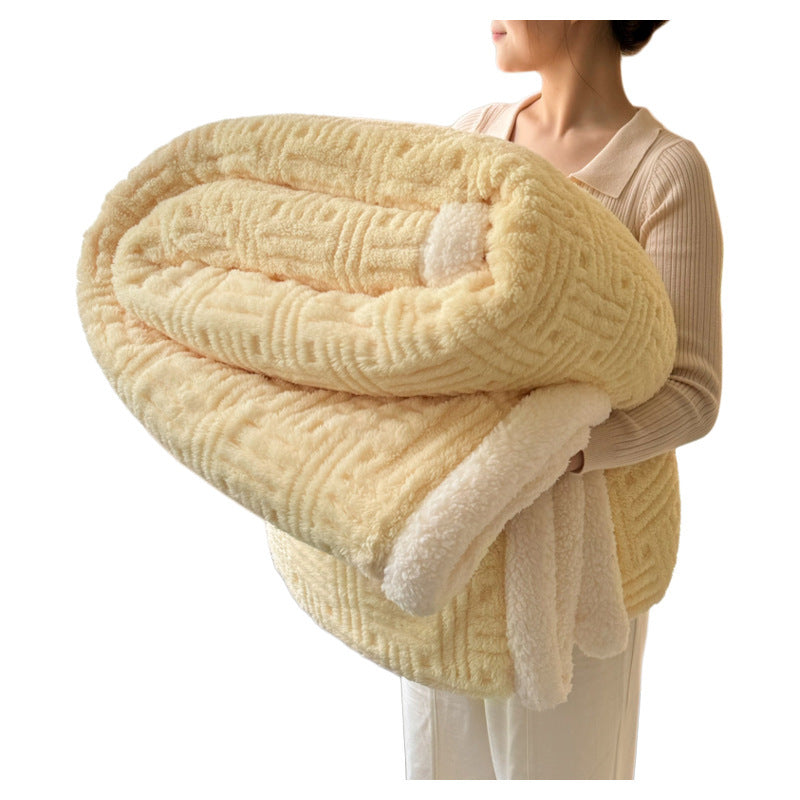 Person holding a folded beige blanket with a white background