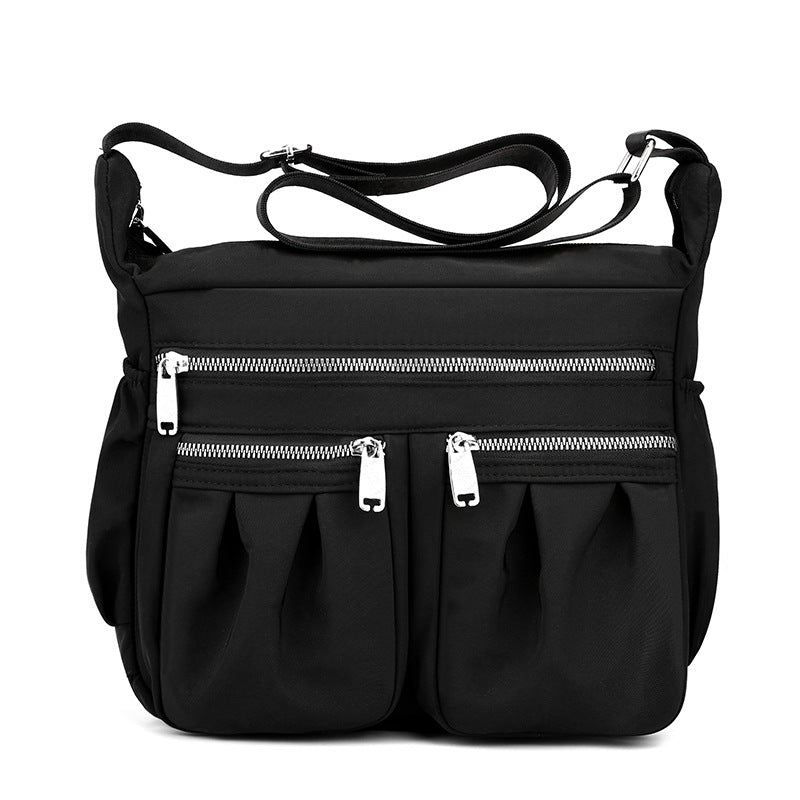 Black crossbody bag with adjustable strap and multiple zip pockets