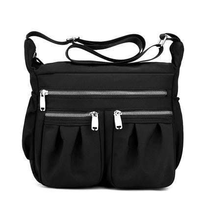 Black crossbody bag with adjustable strap and multiple zip pockets