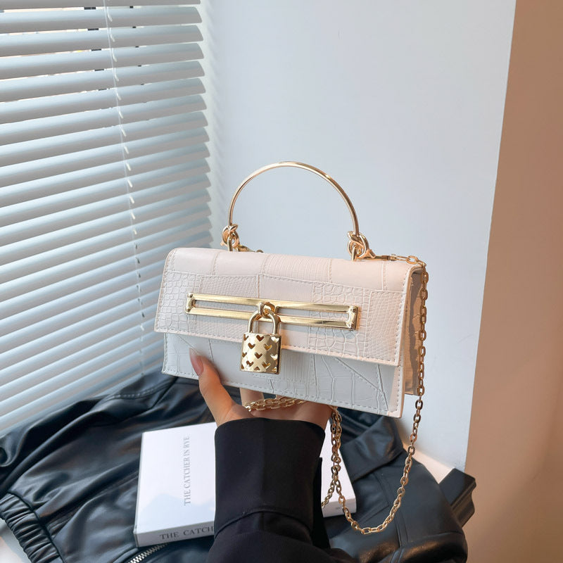 Women’s chain crossbody bag in white PU leather with gold-tone hardware and lock charm