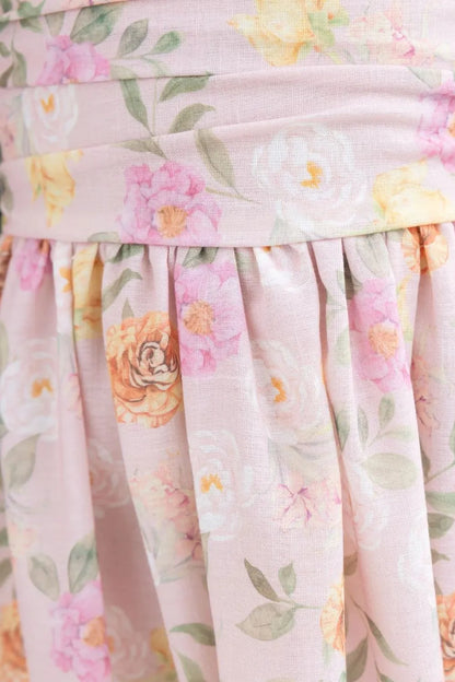 Close-up of a floral dress with pink background