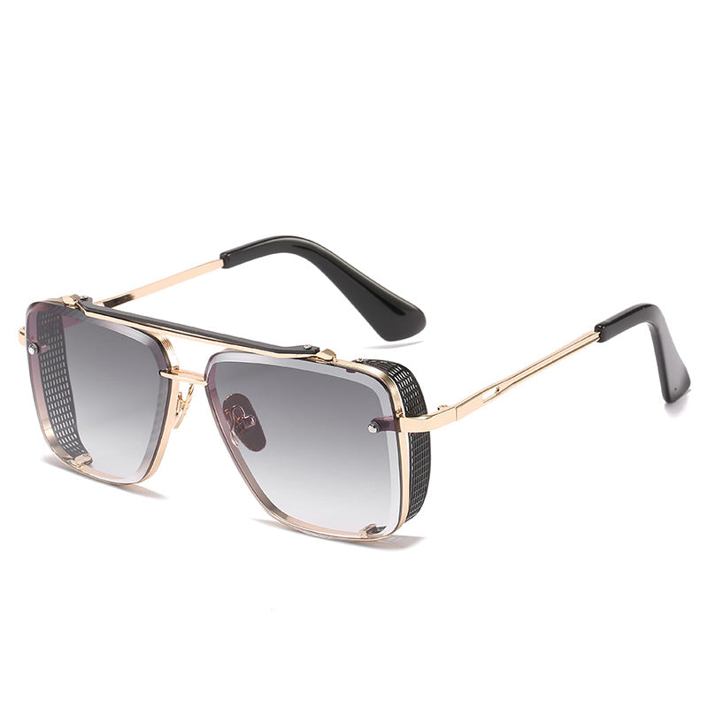 Sunglasses with gold frame and black accents on a white background