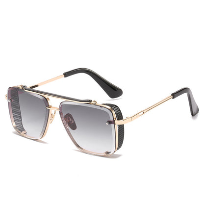 Sunglasses with gold frame and black accents on a white background