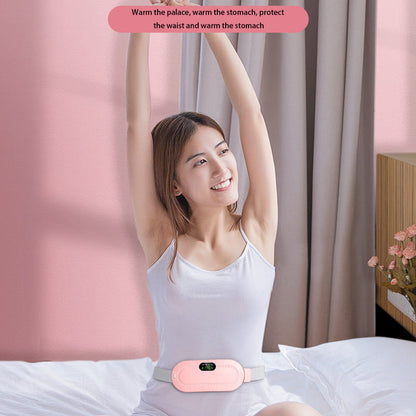 Pink waist massager belt worn at the waist with control panel lit