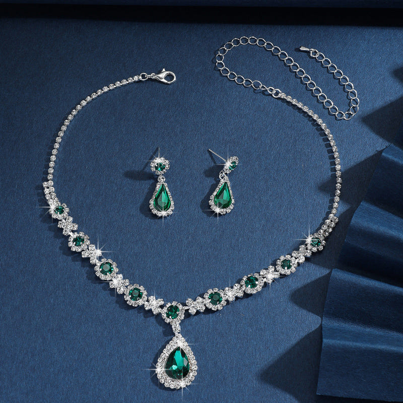 Silver bridal jewelry set with green crystal drop necklace, teardrop pendant, and earrings
