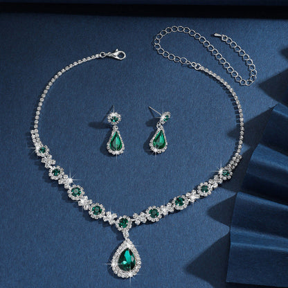 Silver bridal jewelry set with green crystal drop necklace, teardrop pendant, and earrings