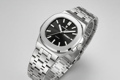 Silver watch with black dial on a beige surface, featuring a certificate of conformity tag.