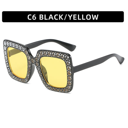 Sunglasses with black frame and yellow lenses on a white background