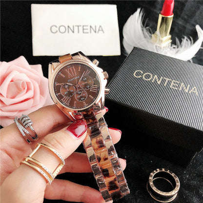 Rose gold watch with tortoiseshell strap held by a hand, surrounded by roses and a Contena box.