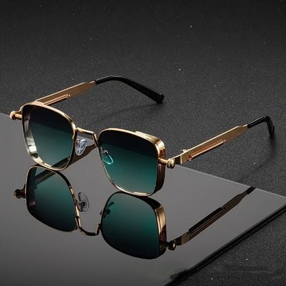 Gold-framed sunglasses with green lenses on a reflective black surface