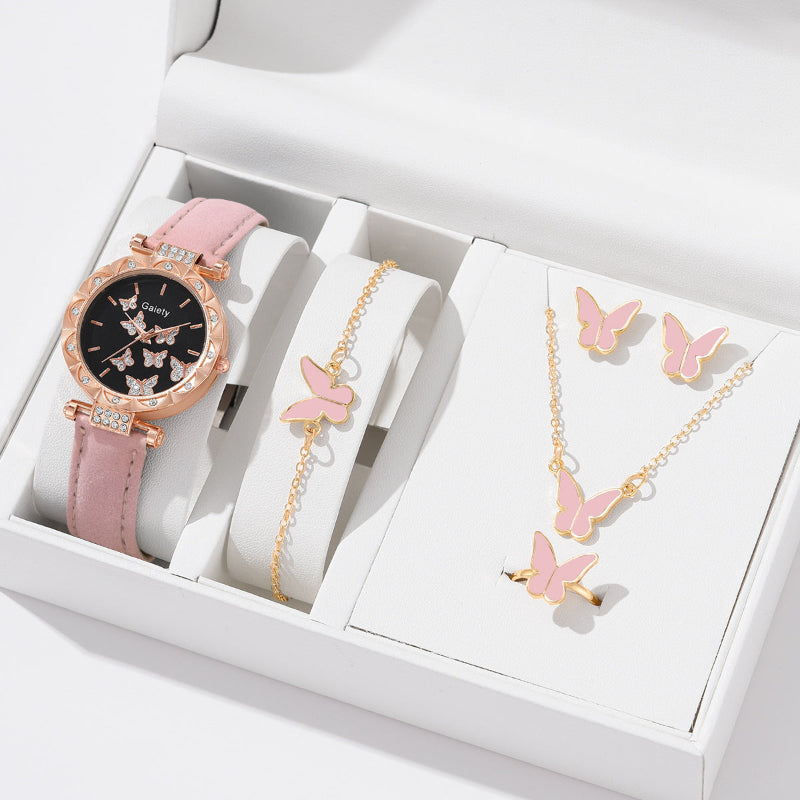 Pink watch, bracelet, and necklace set with butterfly designs in a white box.