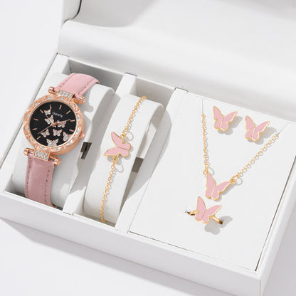 Pink watch, bracelet, and necklace set with butterfly designs in a white box.