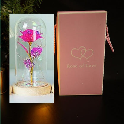 Glowing glass dome rose lamp with pink rose, shown with pink gift box