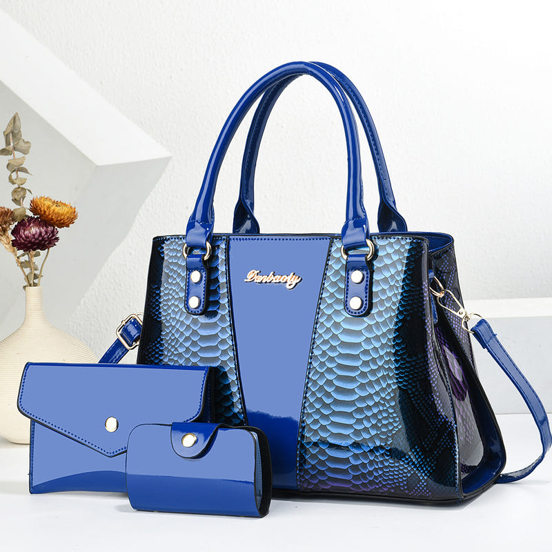 Blue shoulder tote bag with long handles, scalloped texture, front pocket, and wallet