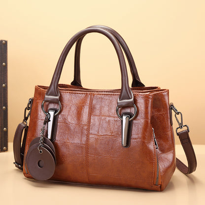 Brown leather-look large-capacity handbag with twin top handles, metal clasps, and side straps