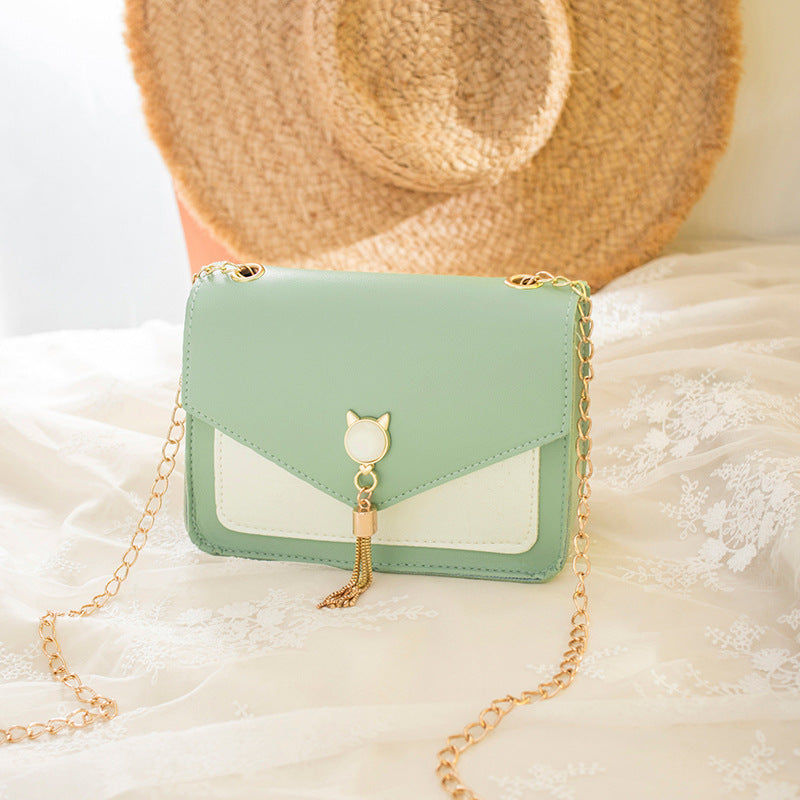 Small square PU leather crossbody bag with flap, tassel chain, mint green and light panels.