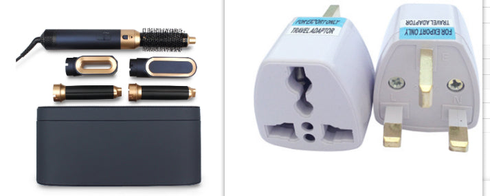 Collection of travel accessories including hair styling tools and adapters on a white background