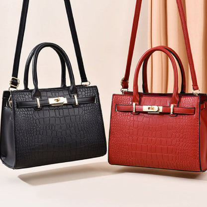 Black and red handbags with gold accents on a light beige background