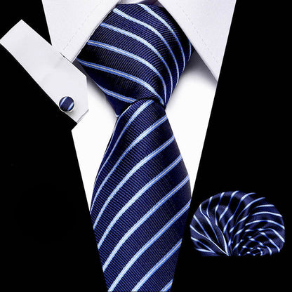 Navy blue and white striped tie with matching pocket square and cufflinks on a black background.