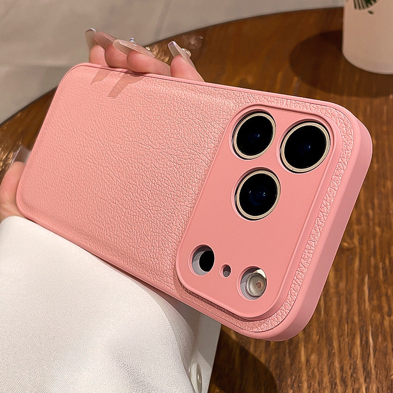 Pink phone case held by a person on a wooden surface