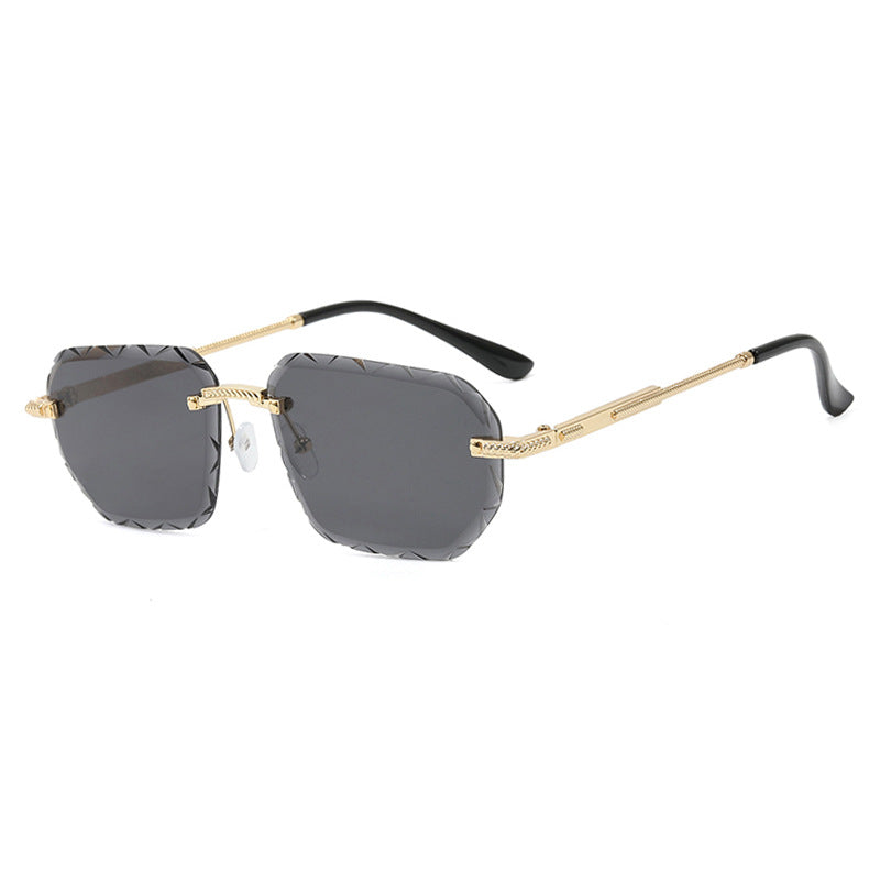 Sunglasses with gold frame and black arms on a white background
