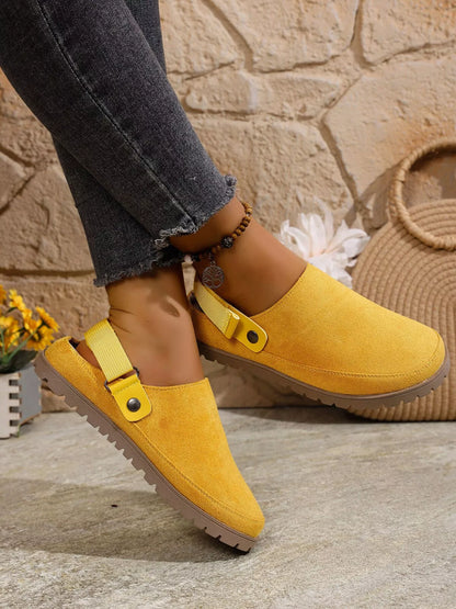 Yellow round-toe slip-on flats with side strap and textured sole