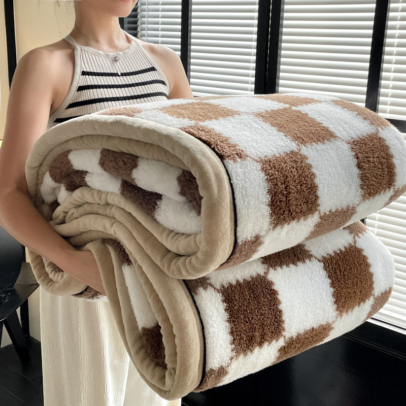 Person holding a checkered blanket with brown and white pattern