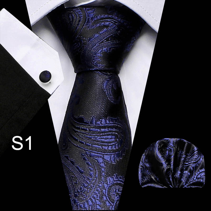 Blue paisley tie with matching pocket square on a white shirt background