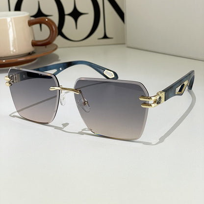Sunglasses with gold and blue frame on a white surface, with a blurred background