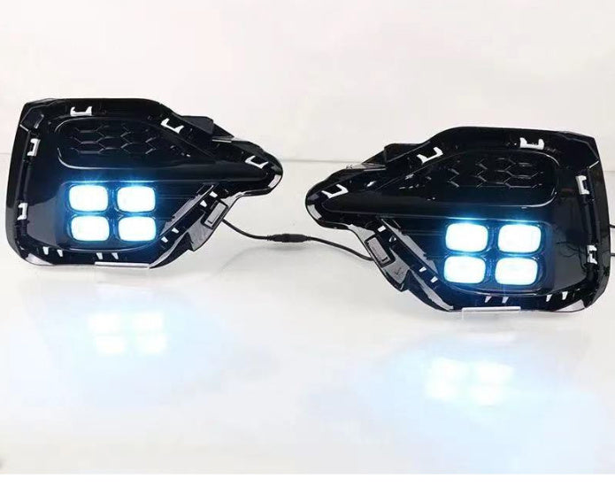 Two black LED lights with blue illumination on a white background