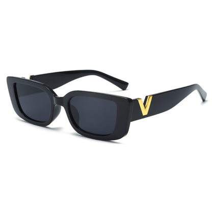 Black sunglasses with a gold 'V' on a white background